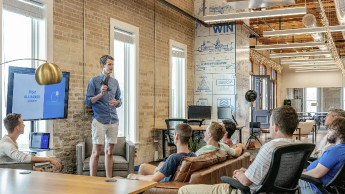 Picture of a project manager with a group of employees 
